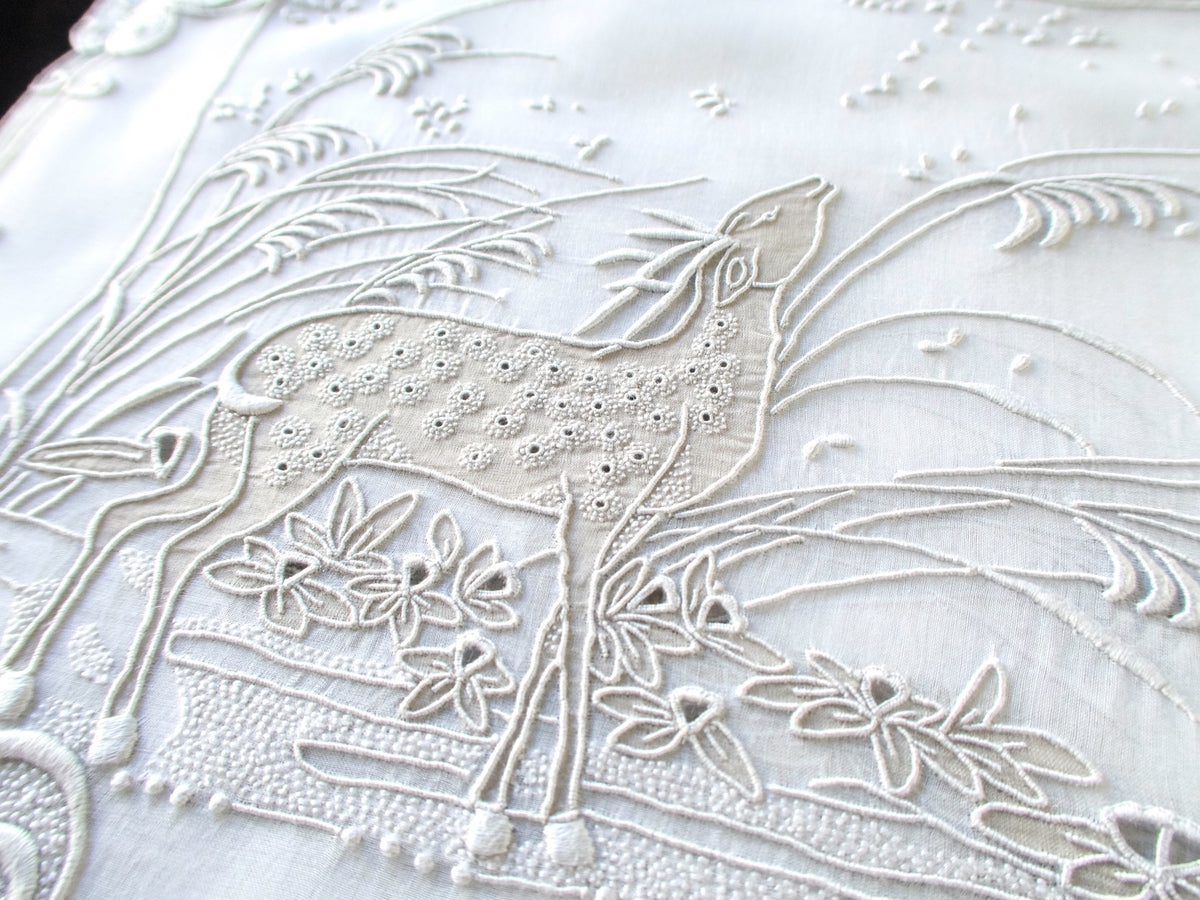Vintage Marghab "Deer" placemat photographed at an angle to show the raised embroidery on the deer and flowers