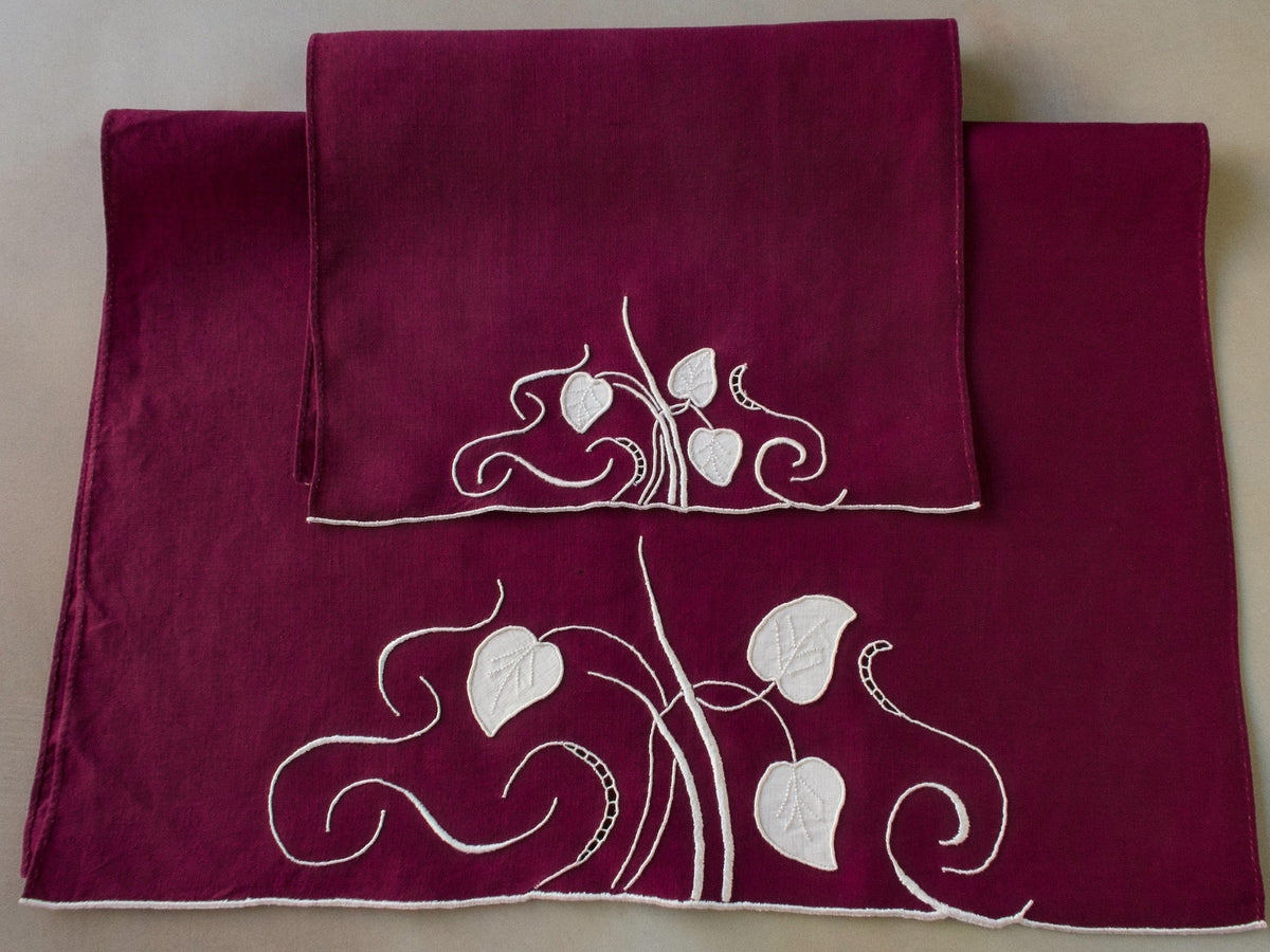 Marghab linen towels in the “Water Leaf” pattern, hand embroidered in plum on fine linen — guest and fingertip sizes shown together.
