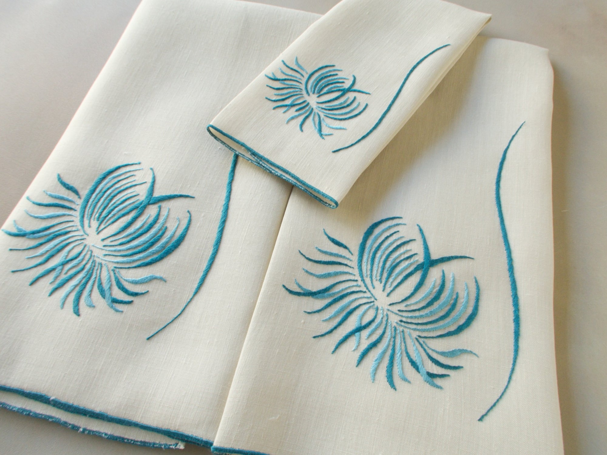 Marghab “Chrysanthemum” linen towel set with two guest towels and one fingertip towel, finely embroidered in Madeira in a graceful floral design.