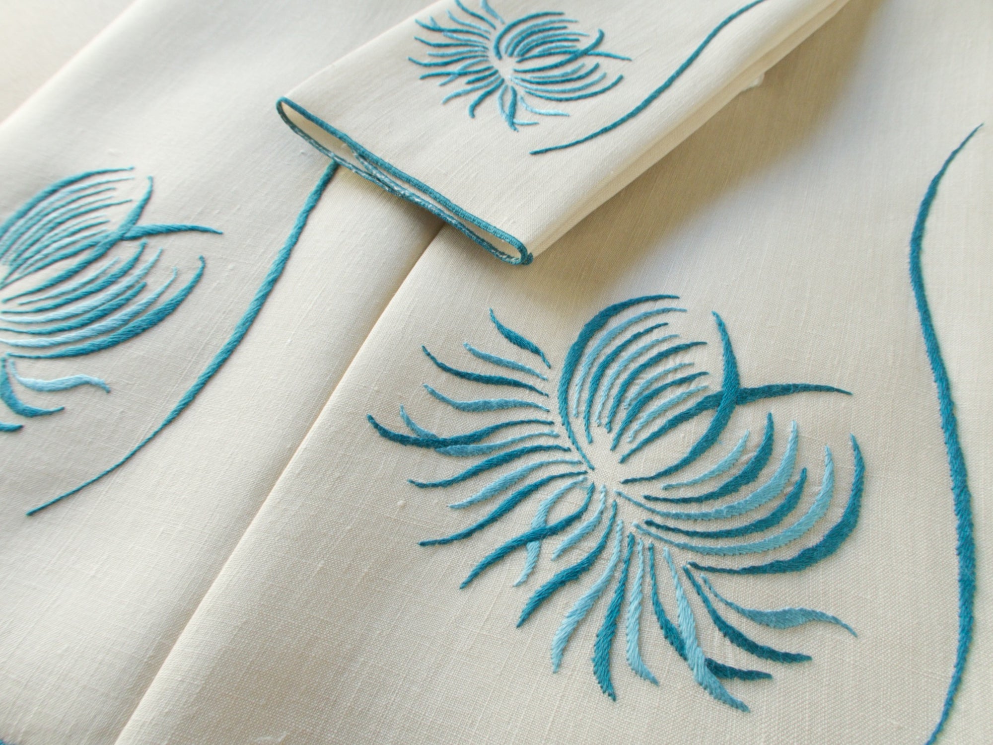 Marghab “Chrysanthemum” linen towel set with two guest towels and one fingertip towel, finely embroidered in Madeira in a graceful floral design.