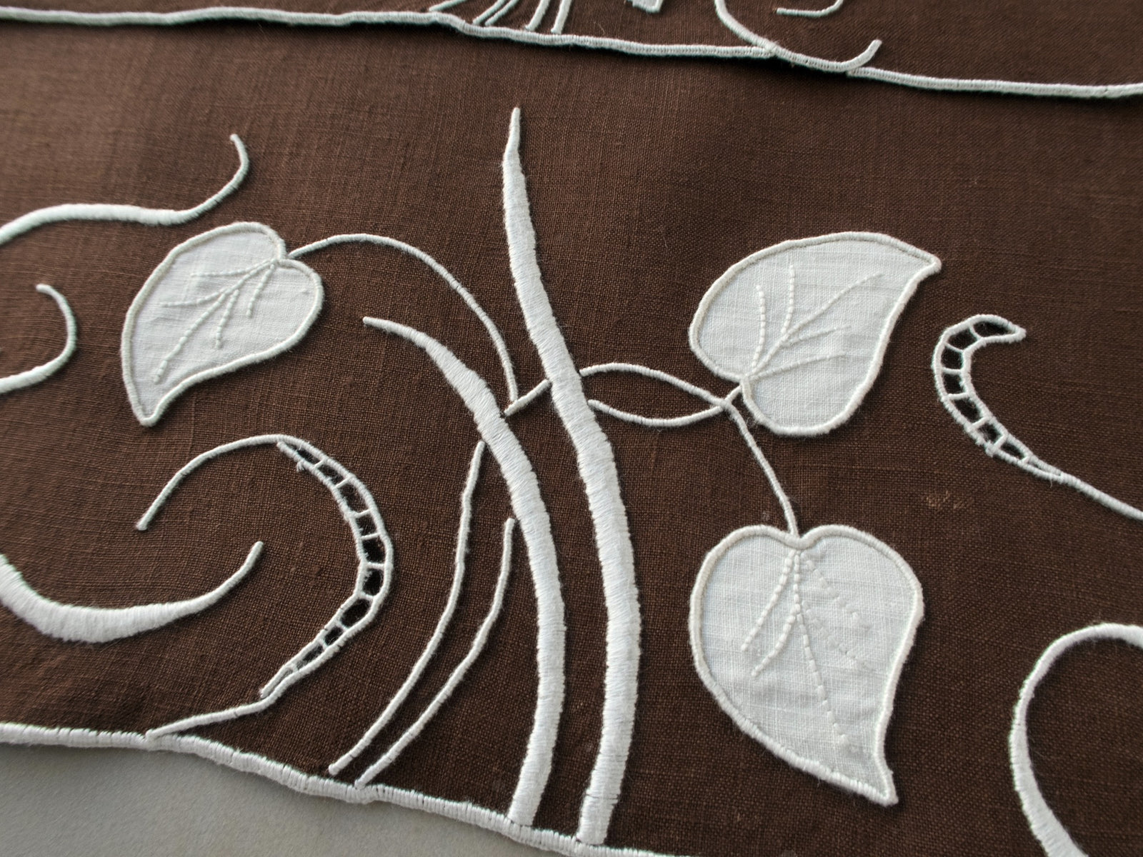 Marghab linen towels in the “Water Leaf” pattern, hand embroidered in brown on fine linen.