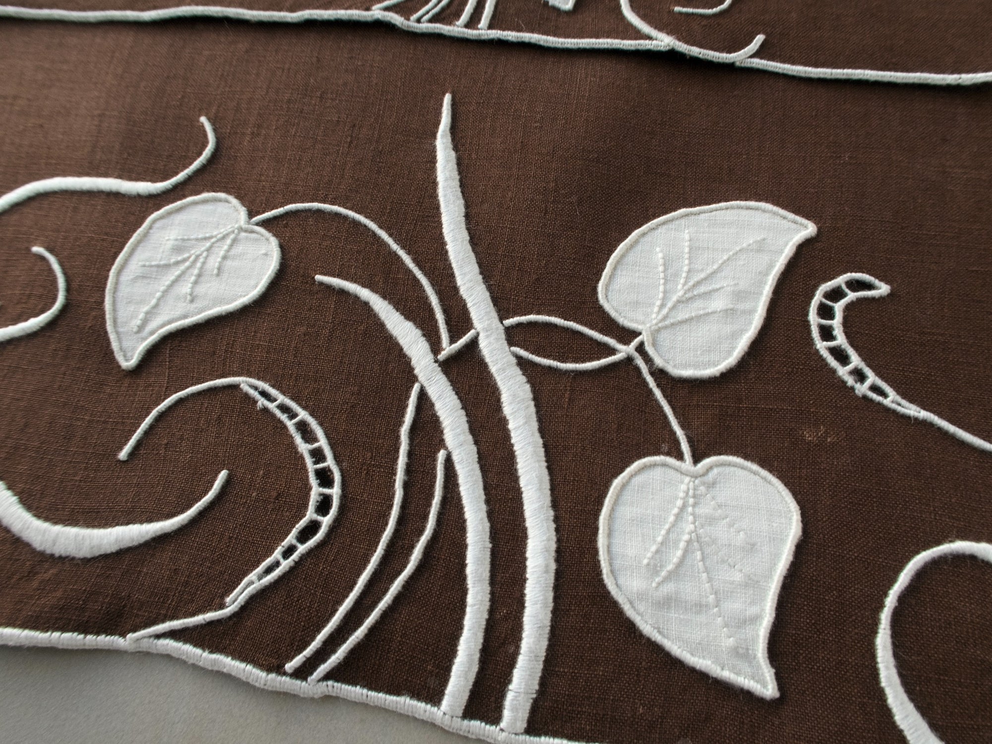 Marghab linen towels in the “Water Leaf” pattern, hand embroidered in brown on fine linen.