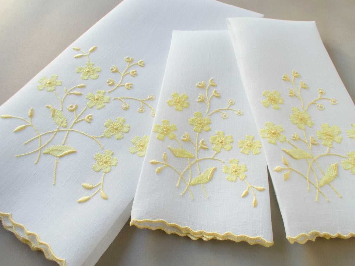 Vintage Marghab linen towels in the “Spray” pattern, hand embroidered in yellow on white linen.