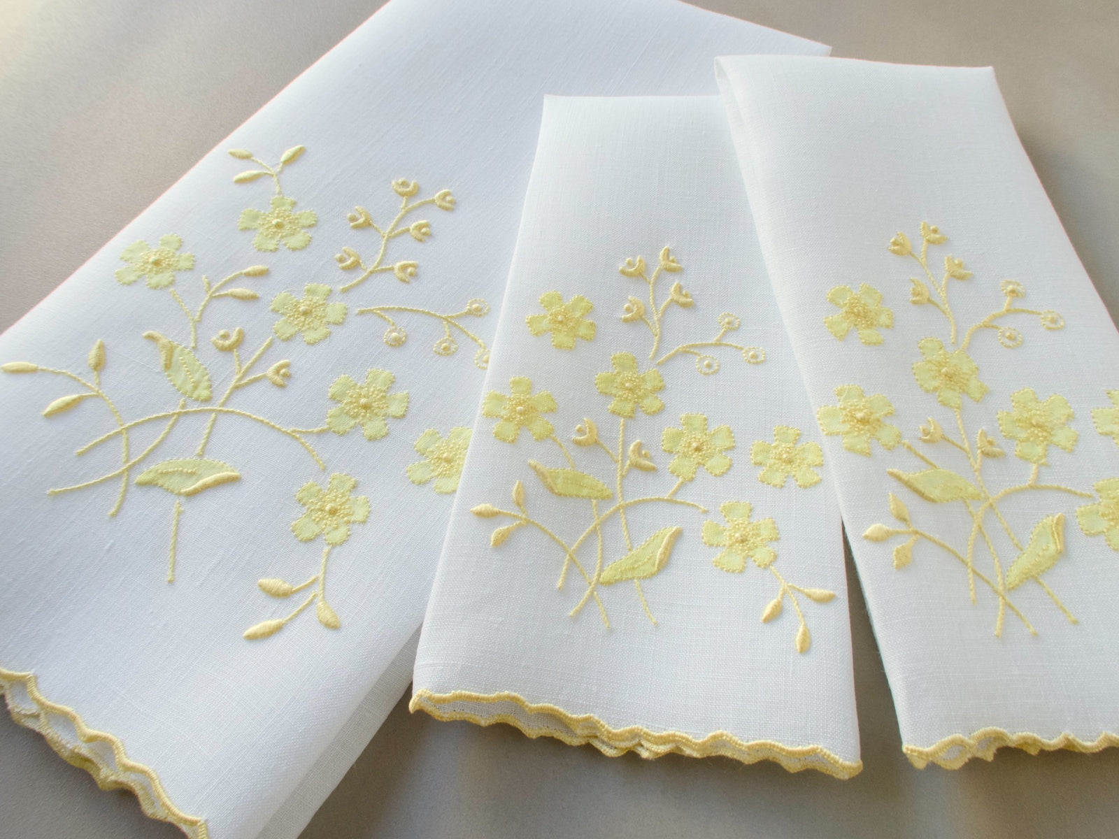 Vintage Marghab linen towels in the “Spray” pattern, hand embroidered in yellow on white linen.