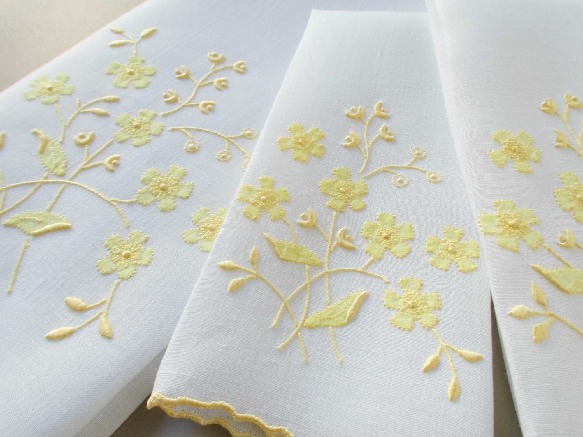Vintage Marghab linen towels in the “Spray” pattern, hand embroidered in yellow on white linen.