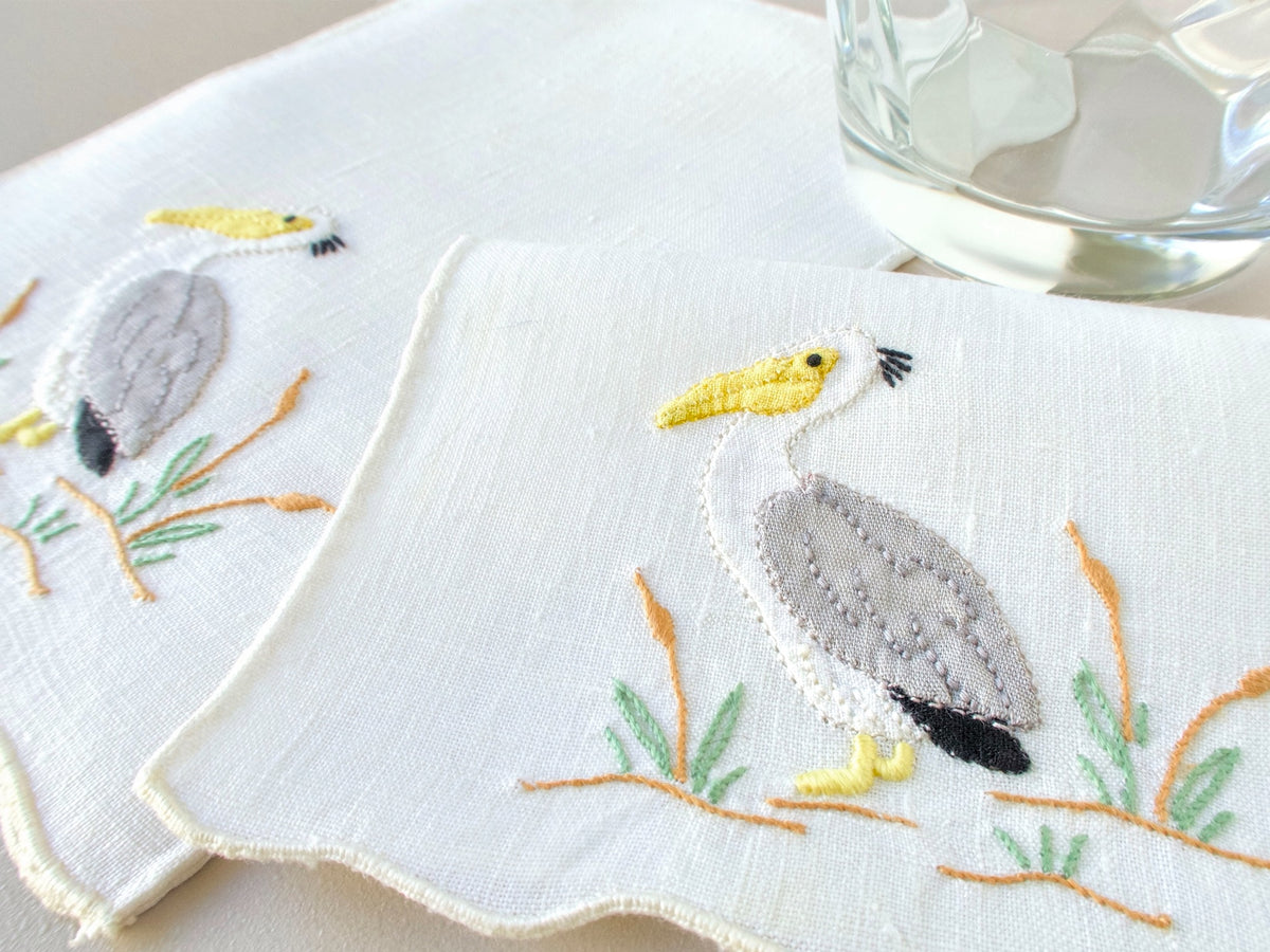 Vintage Madeira hand embroidered cocktail napkins, set of 6, pelican at water’s edge with reeds and grasses on fine white linen.