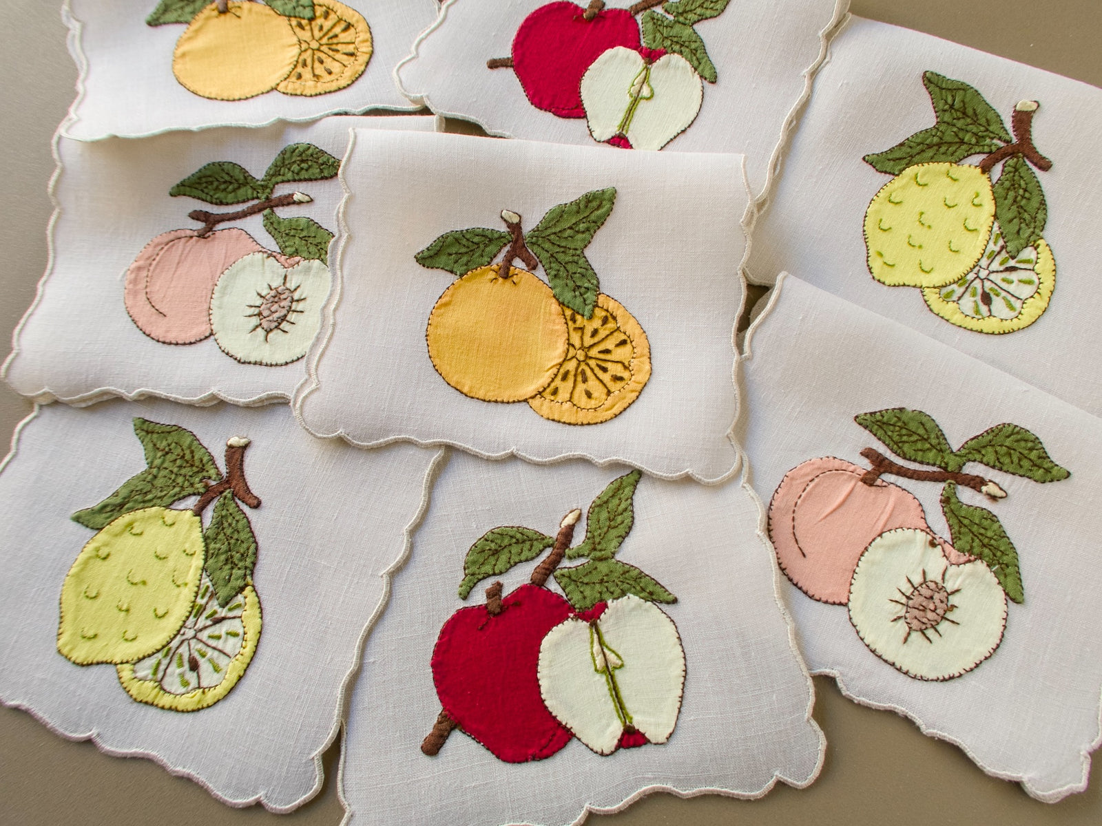 Set of eight vintage Madeira cocktail napkins with appliqué fruits and scalloped edges