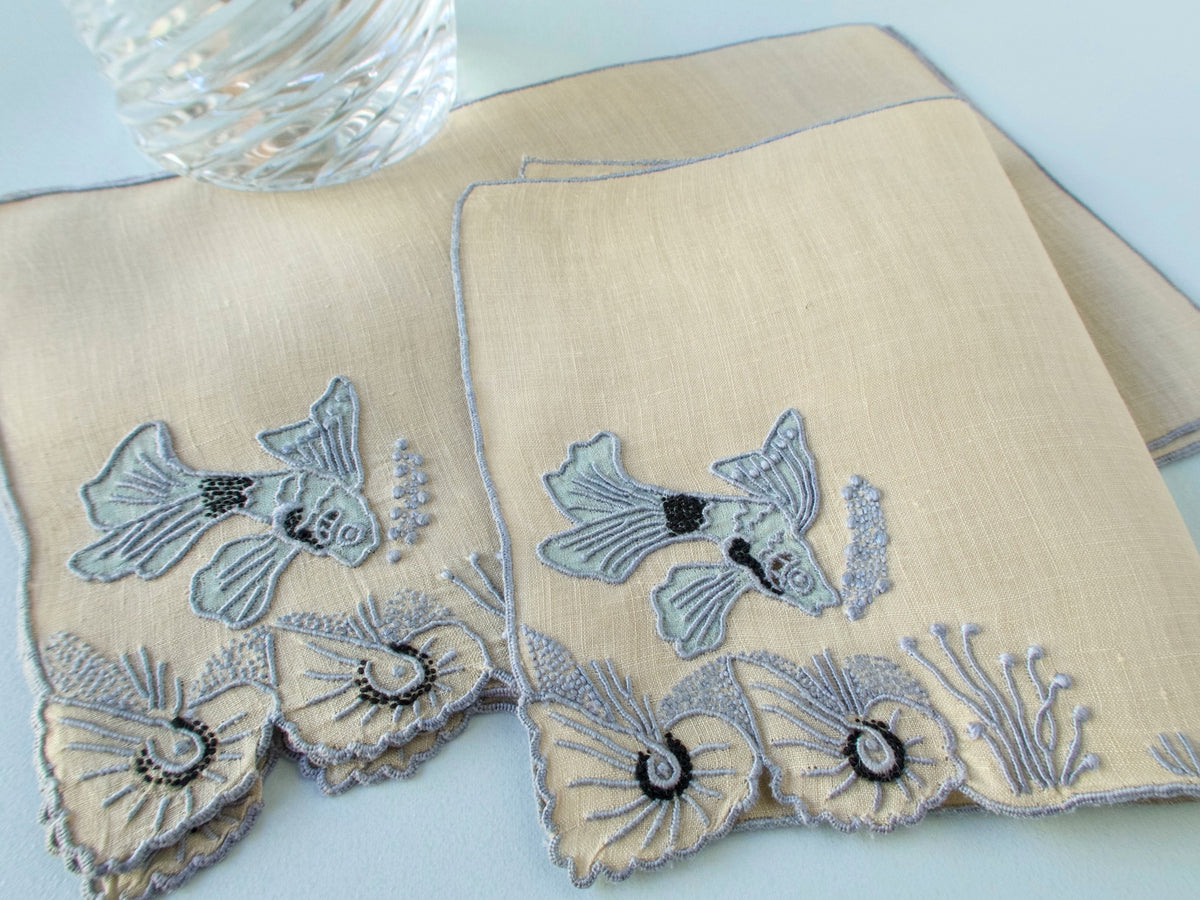 Close view of Marghab “Tropical Fish” hand embroidery on vintage Irish linen cocktail napkin, fish with shells and coral detail.​​​​​​​​​​​​​​​​