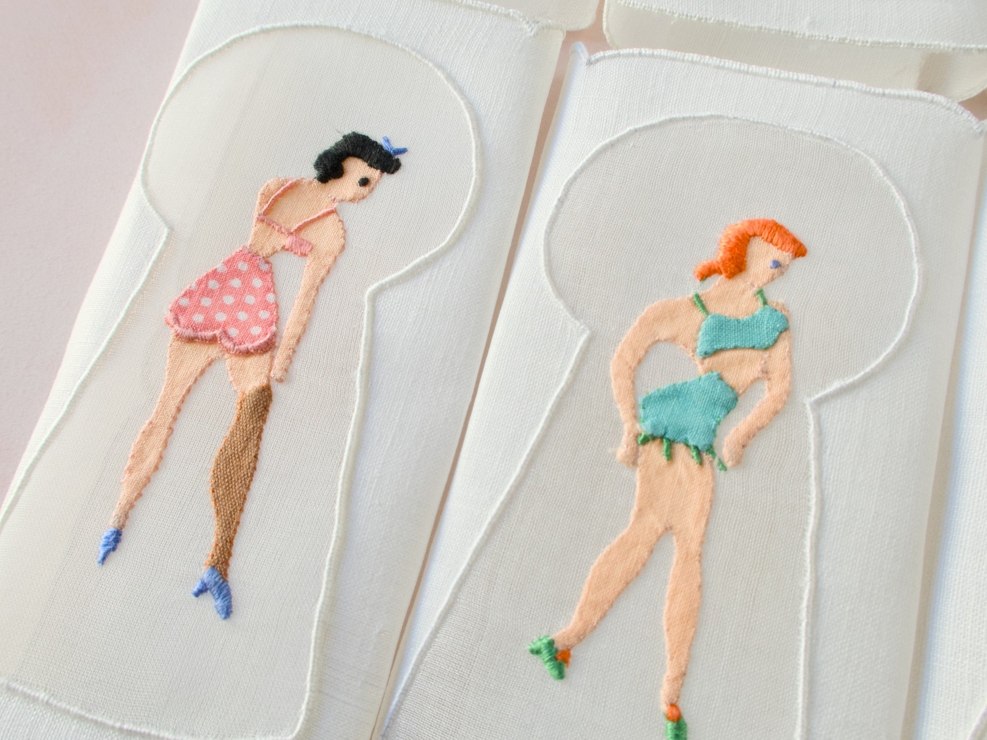 Detail of keyhole embroidery showing woman in green lingerie, vintage Madeira linen cocktail napkin.