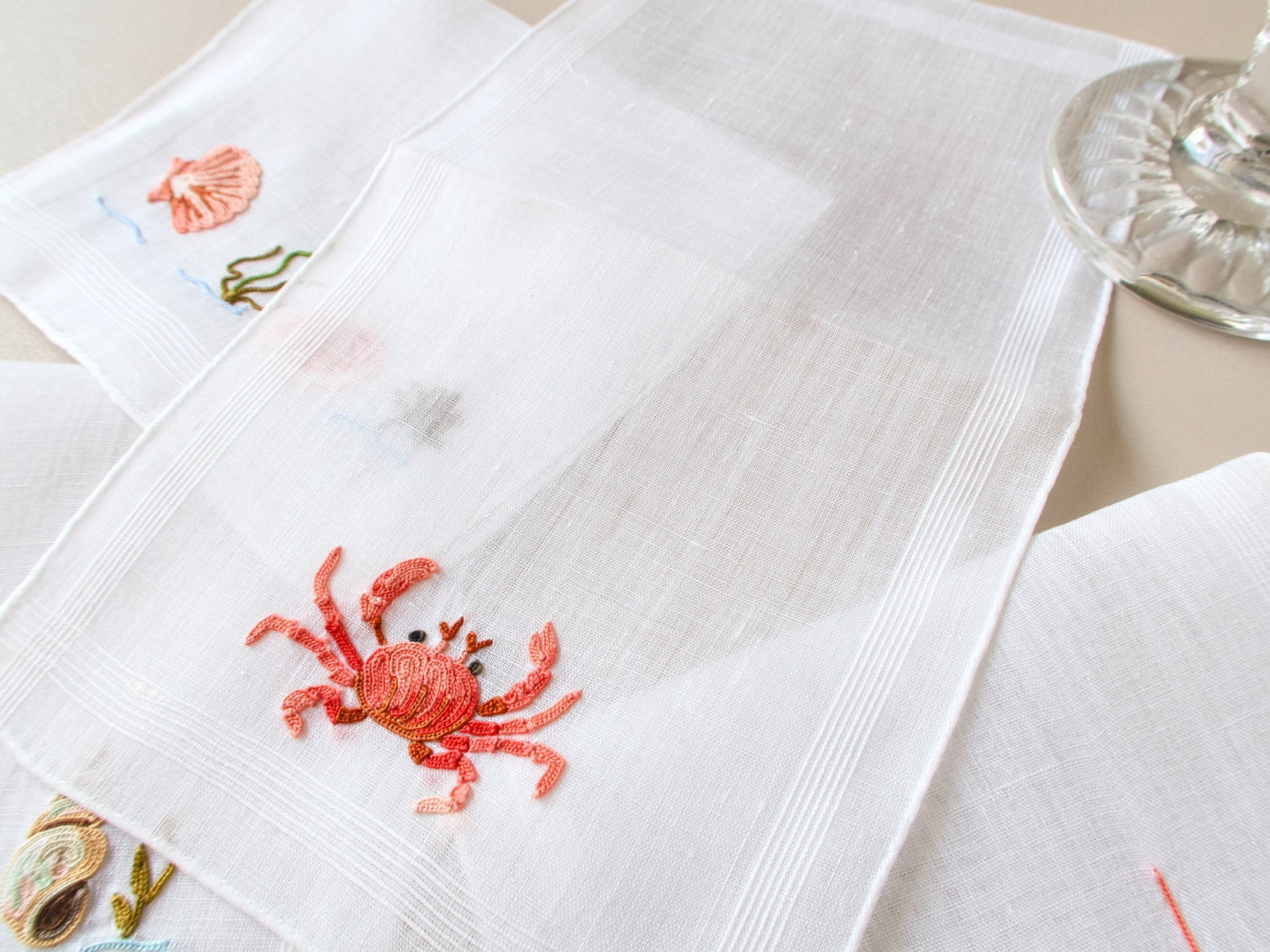 Detail of hand embroidered crab and shell in Point de Beauvais on vintage French linen cocktail napkin.​​​​​​​​​​​​​​​​