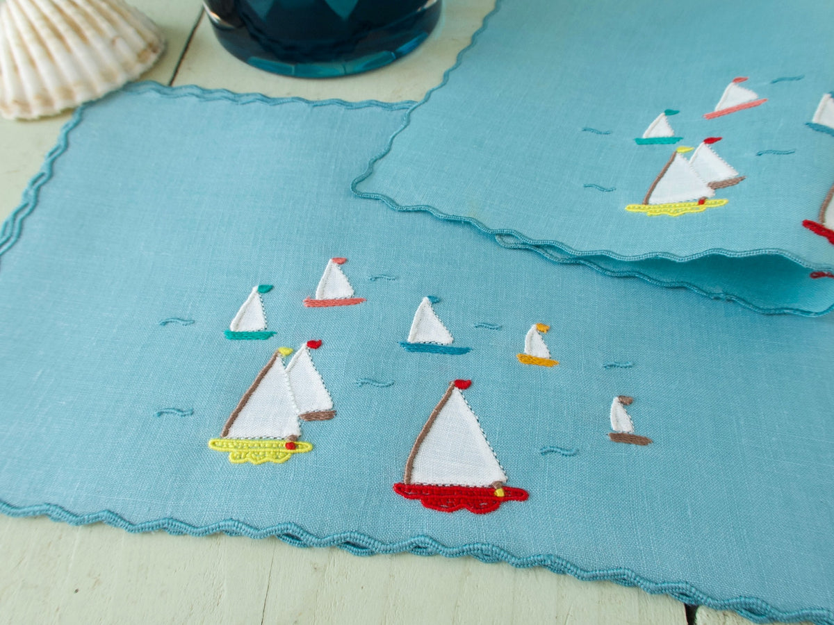 Vintage Marghab cocktail napkins, set of 6, colorful fishing boats with bright hulls on brilliant blue sea, hand embroidered on fine Irish linen.