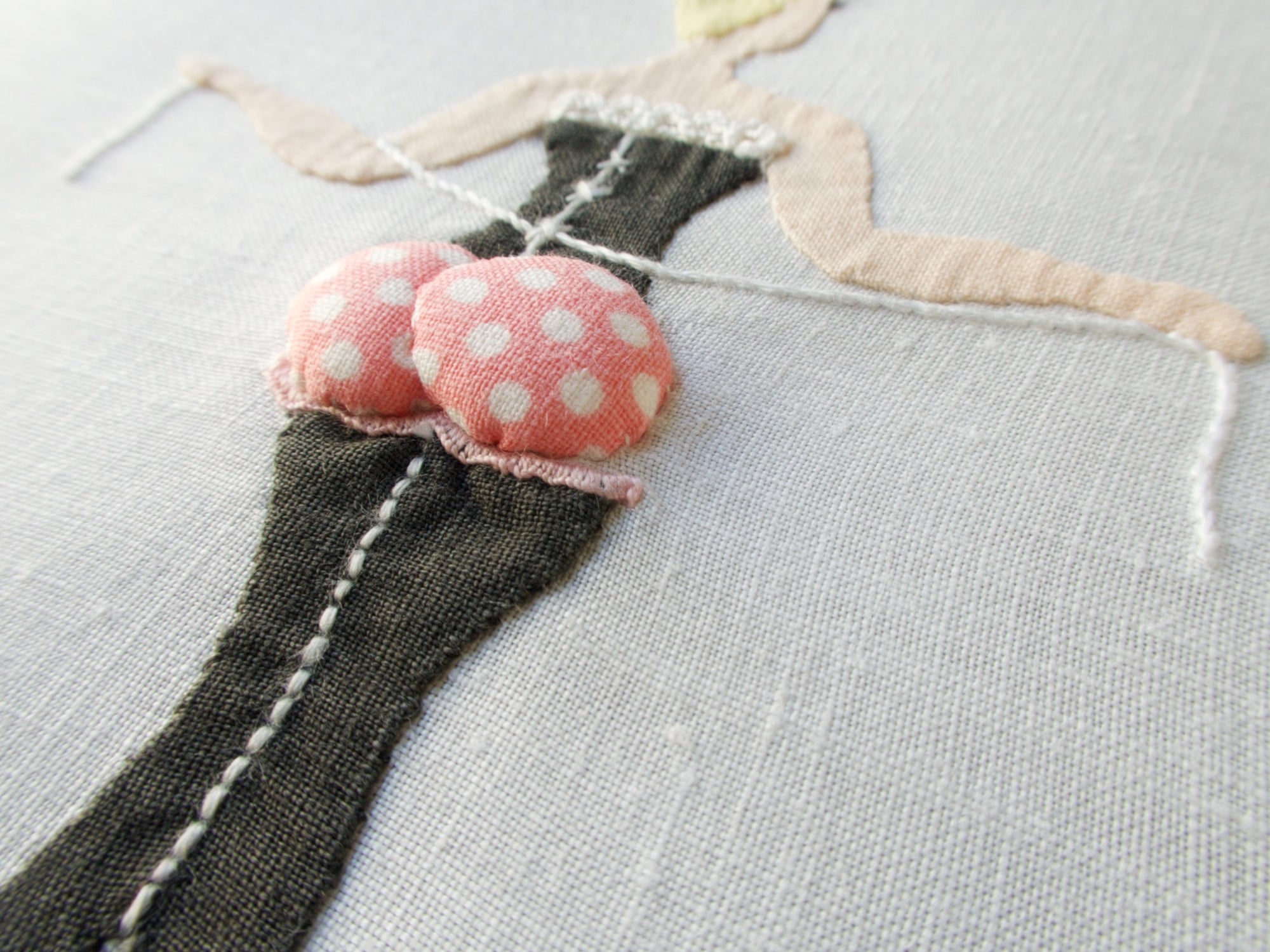 Close-up of vintage Madeira linen cocktail napkin by Paragon featuring playful hand-embroidered ladies with dimensional appliqué