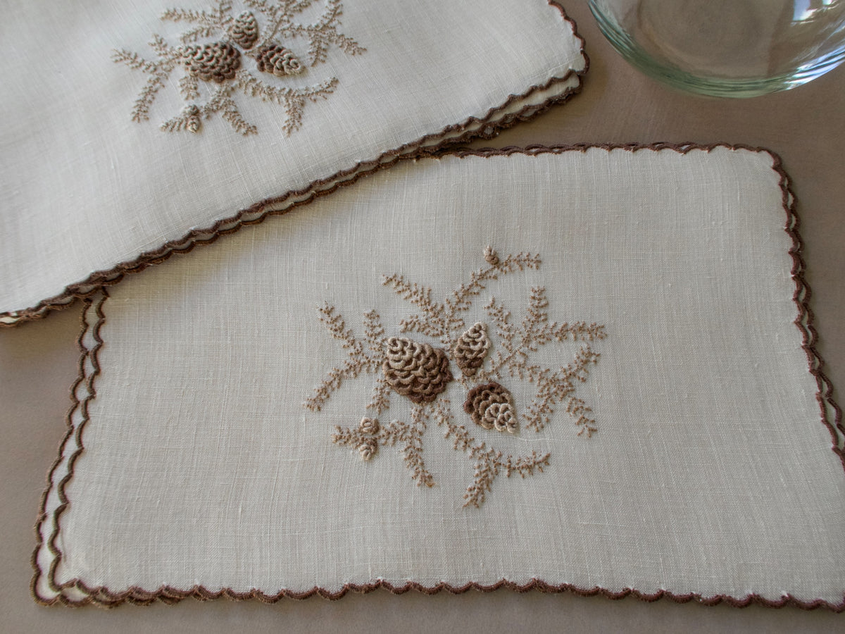 Vintage Marghab cocktail napkins in the “Pine Cones” pattern on fine linen, hand embroidered in Madeira with raised pinecone motifs and a scalloped edge.