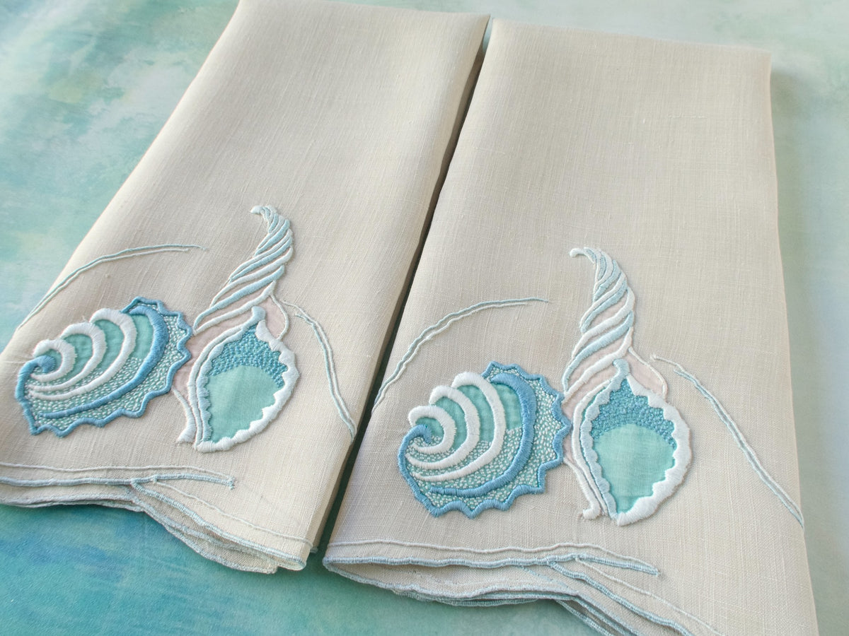 Close view of Marghab “Concha” blue shell hand embroidery on vintage Irish linen guest towel, Madeira detail.