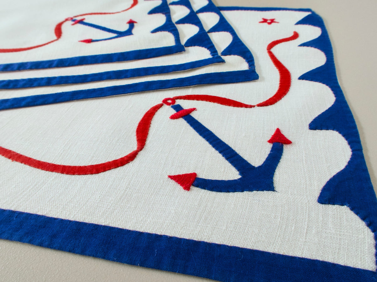 Vintage nautical linen placemats, set of 4, blue anchor and red stars on white linen with scalloped blue border, bold graphic design.