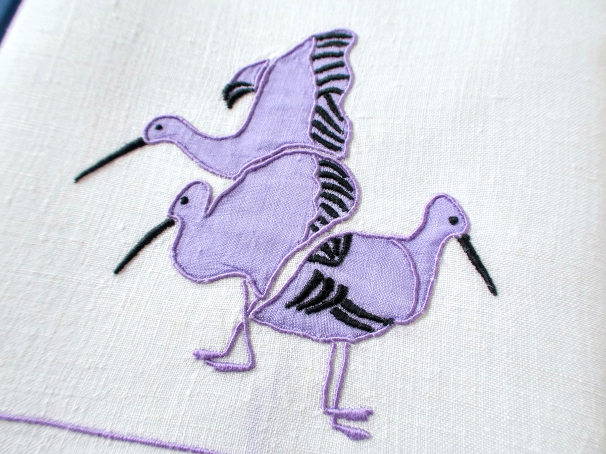 Close view of modernist water birds appliqué with bullrushes on vintage white linen hand towel, mid-century design.
