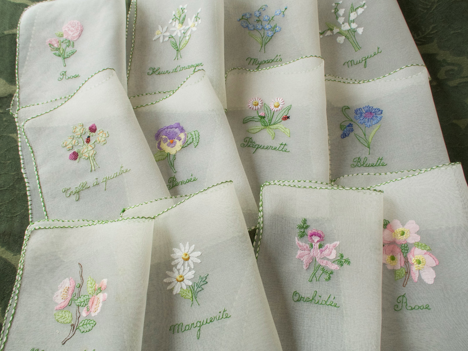 Vintage silk chiffon cocktail napkins hand embroidered with French flower names and delicate floral motifs.