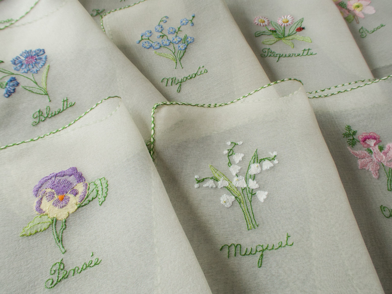 Vintage silk chiffon cocktail napkins hand embroidered with French flower names and delicate floral motifs.