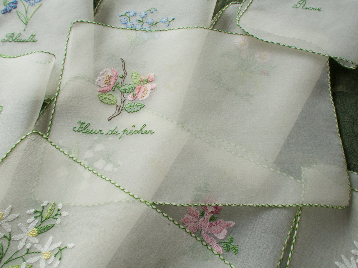 Vintage silk chiffon cocktail napkins hand embroidered with French flower names and delicate floral motifs.