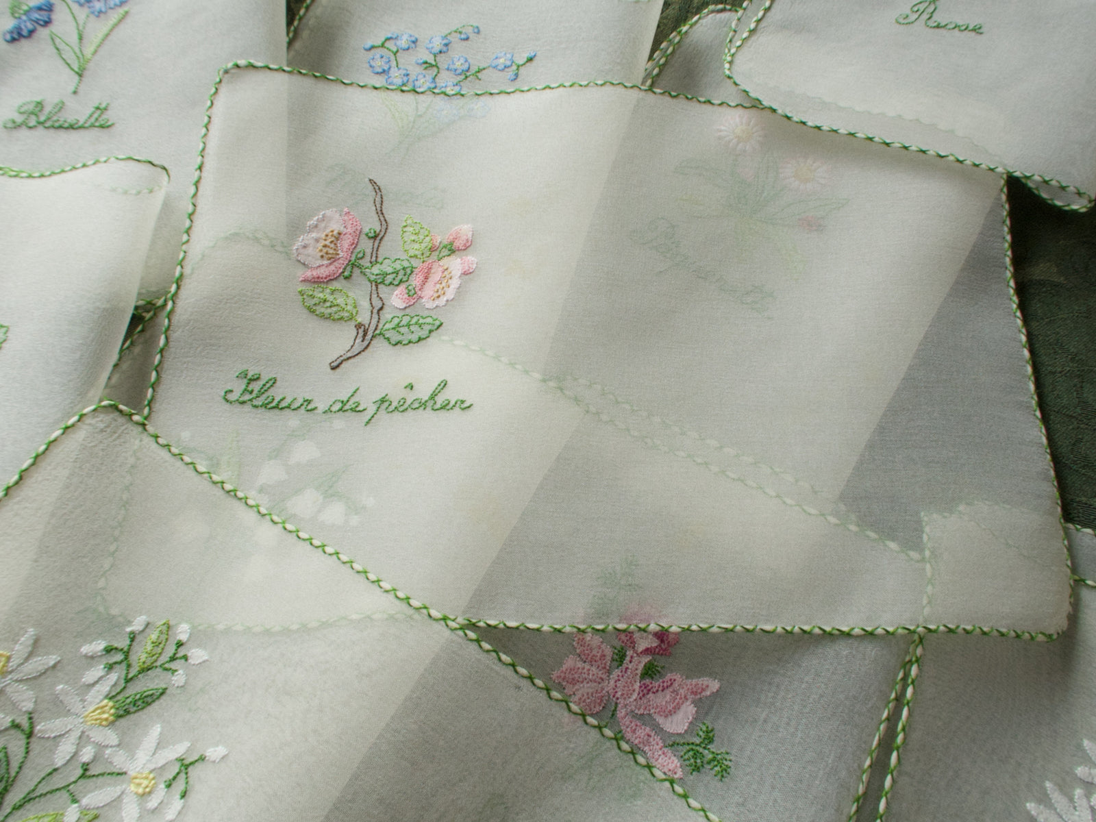 Vintage silk chiffon cocktail napkins hand embroidered with French flower names and delicate floral motifs.