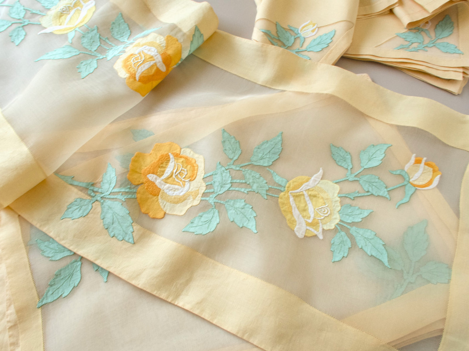 Vintage Madeira organdy table runner showing yellow rose and sage green leaf linen appliqué design
