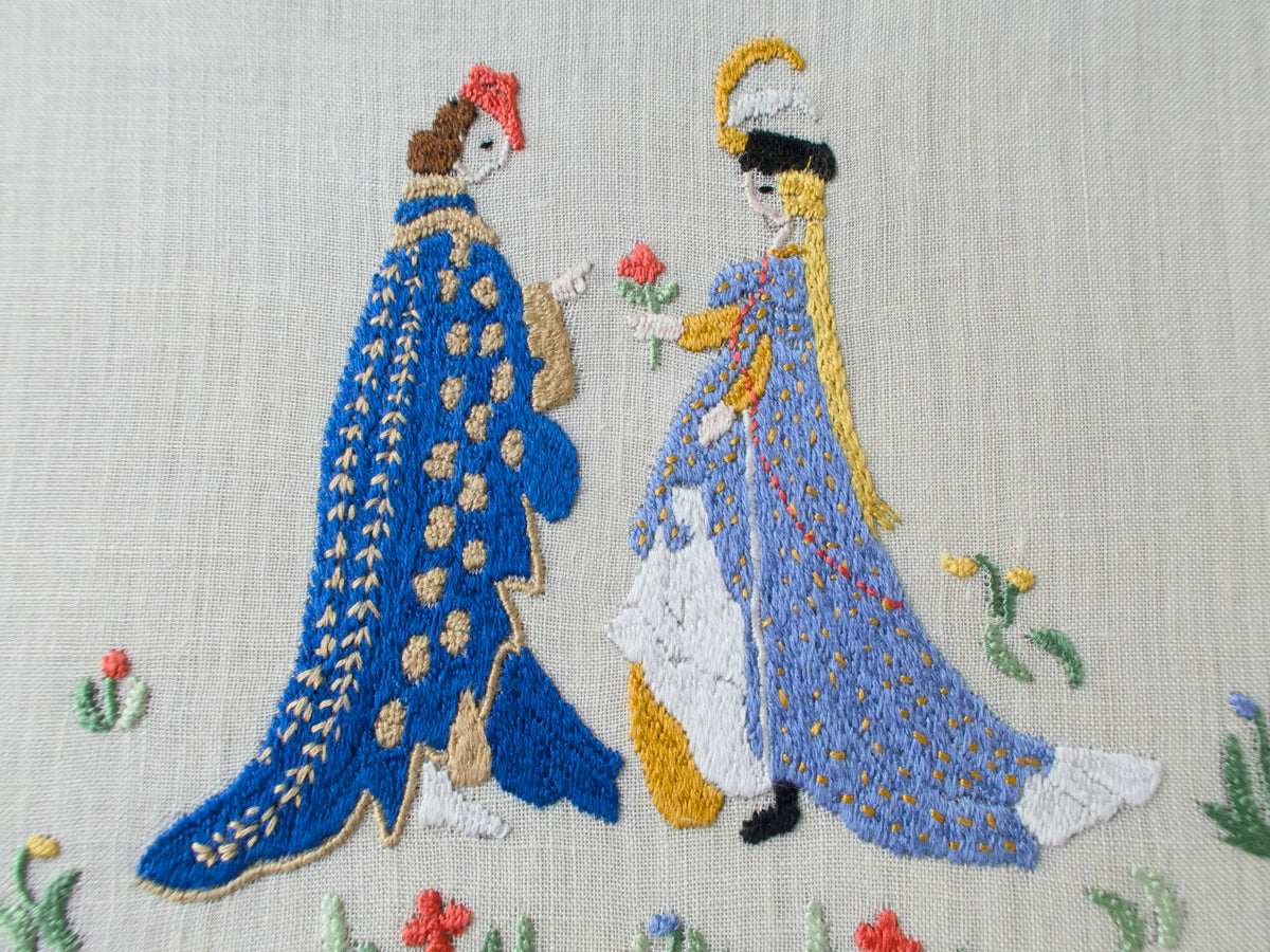detailed view of medieval lovers, hand embroidered on semi sheer linen