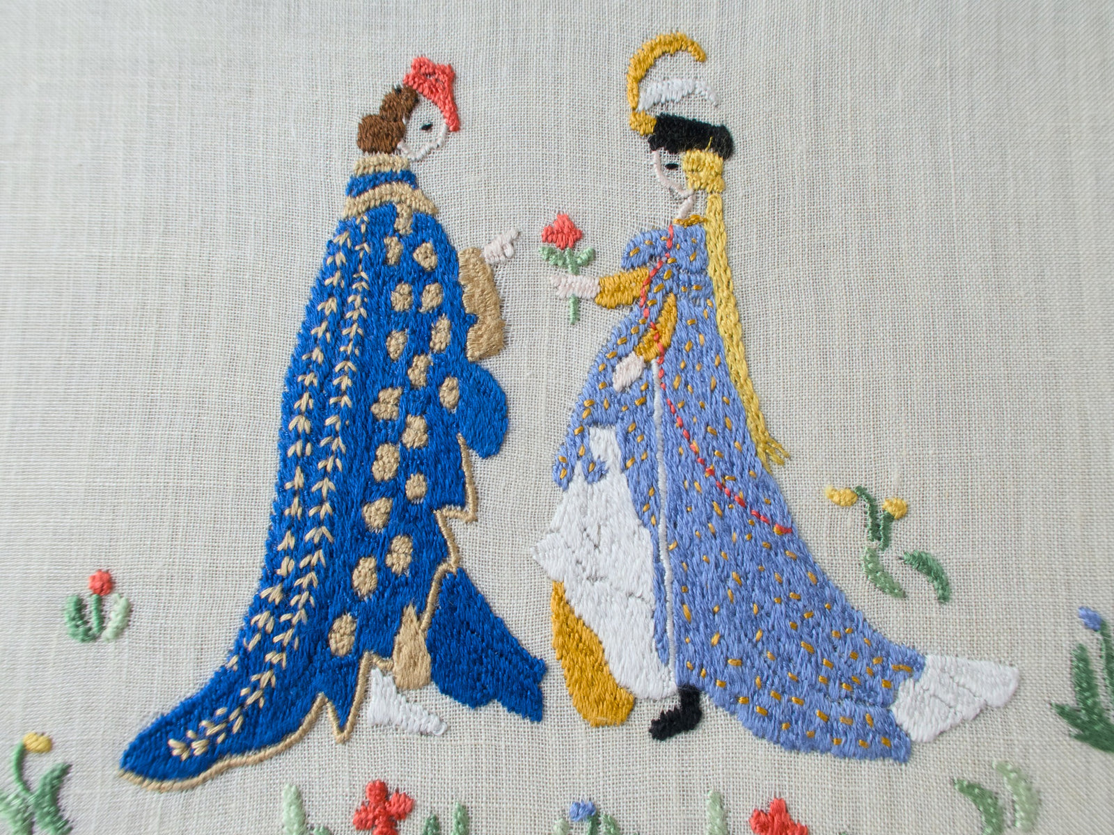 detailed view of medieval lovers, hand embroidered on semi sheer linen