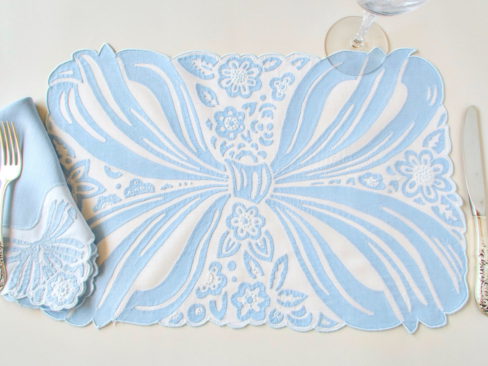 Ornate blue bow in embroidery and applique, vintage Madeira hand embroiderd placemat set.