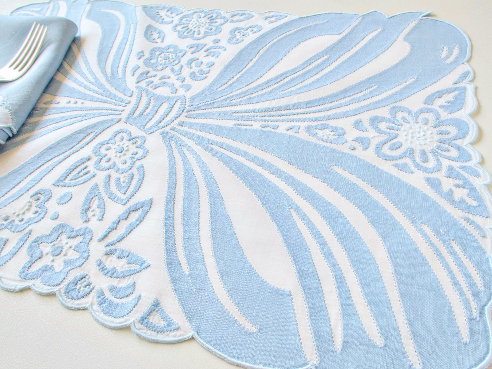 Ornate blue bow in embroidery and applique, vintage Madeira hand embroidered placemat set.