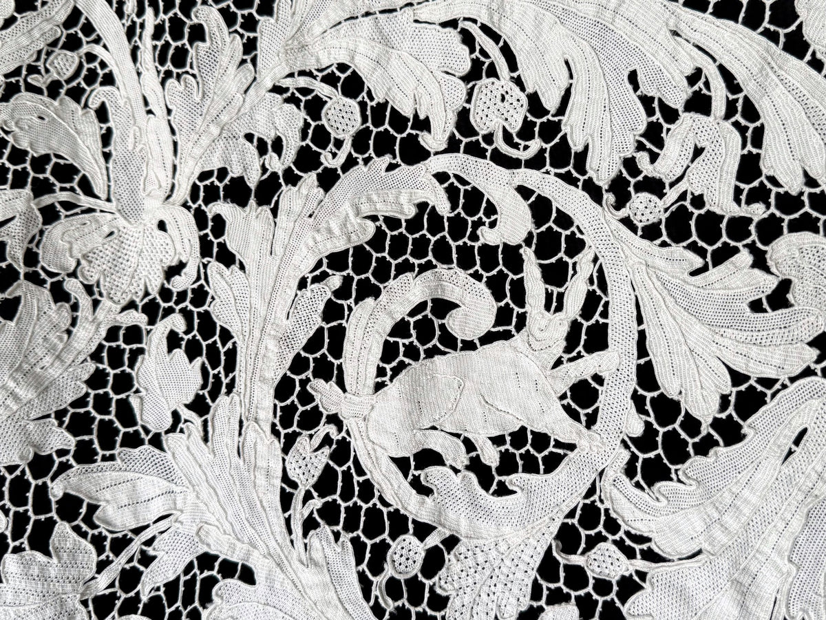 Rabbit leaping through leafy scrollwork in a close view of the lace.