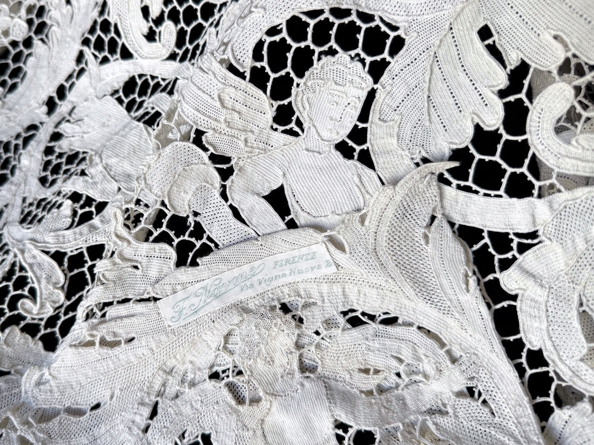 Reclining figure in the lace beside the tablecloth’s original Florence shop label.