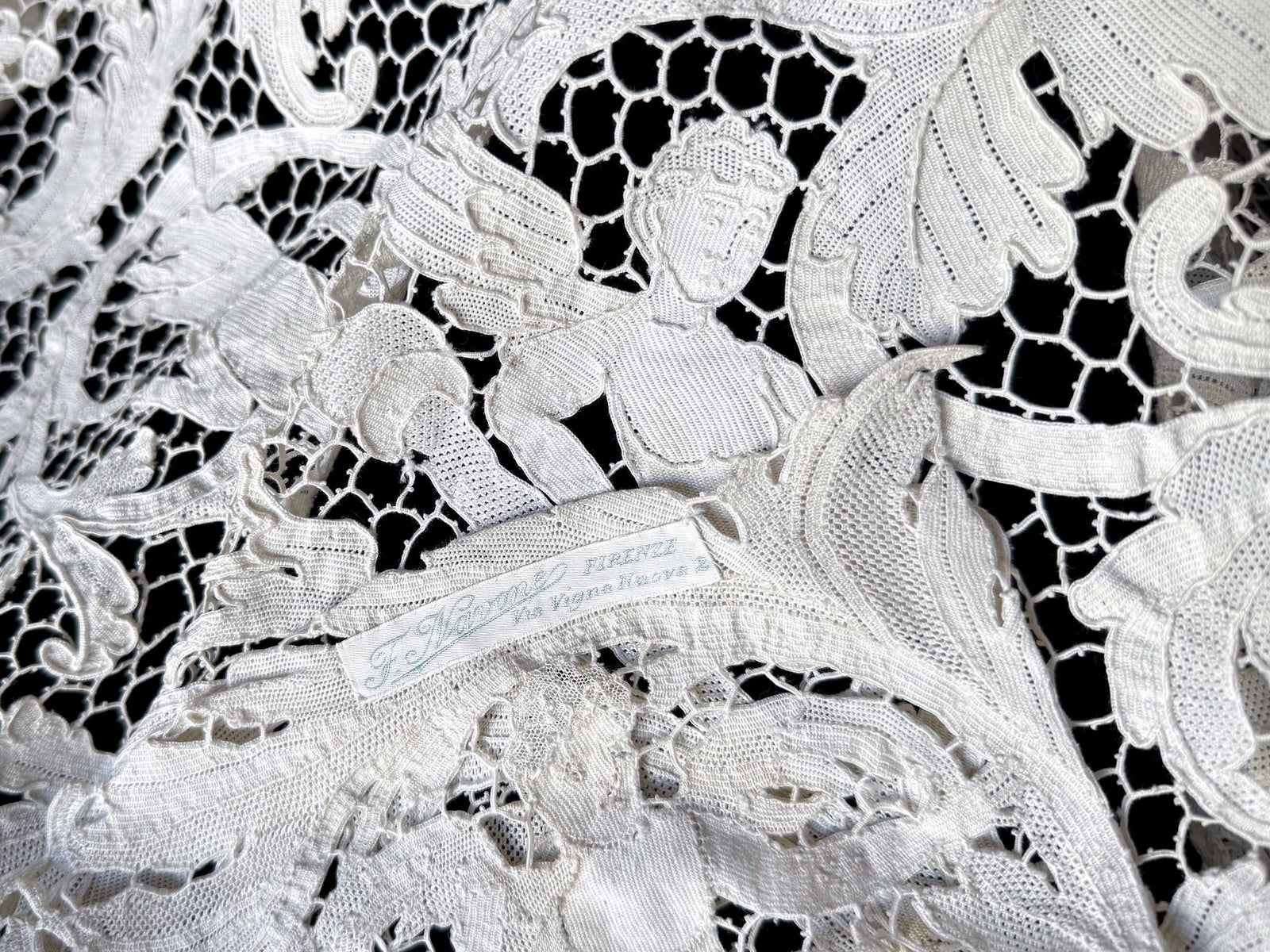 Reclining figure in the lace beside the tablecloth’s original Florence shop label.
