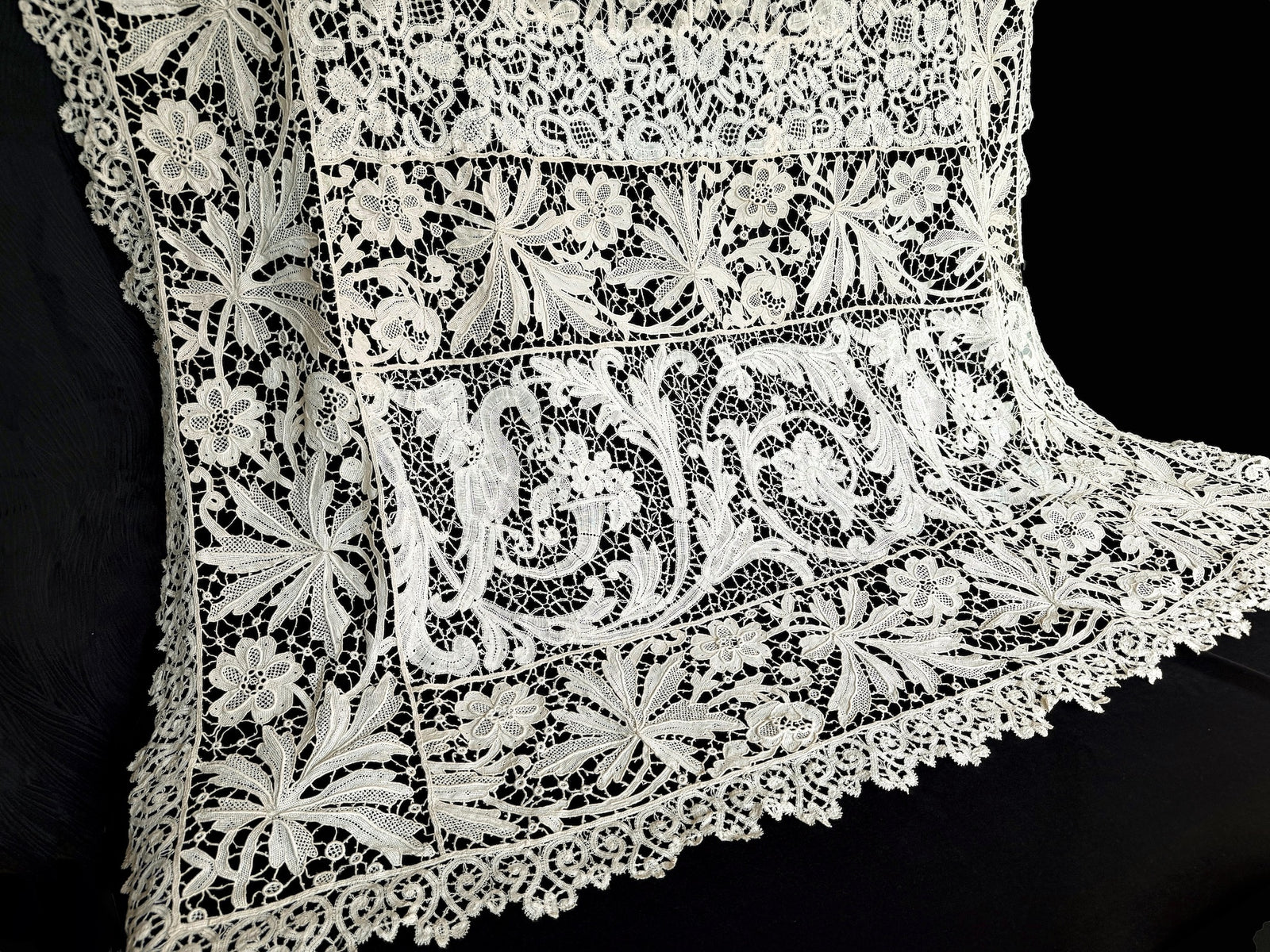 Antique French lace tablecloth end panel with a pair of cranes among scrolling foliage, framed by floral lace bands