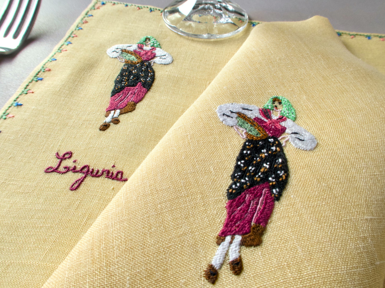 Rapisardi placemat featuring embroidered woman in purple and black dress