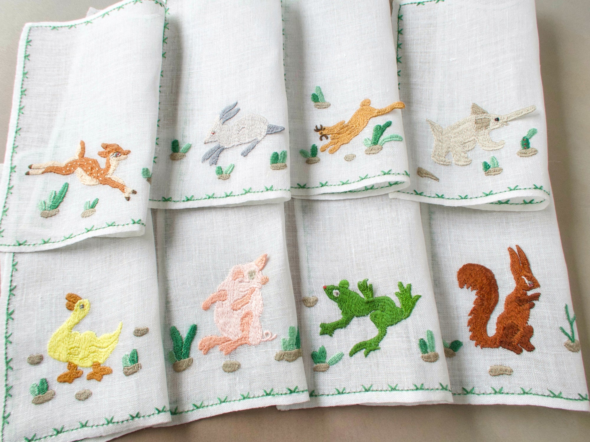 Set of Rapisardi animal cocktail napkins showing rabbit, duck, frog, and squirrel motifs.