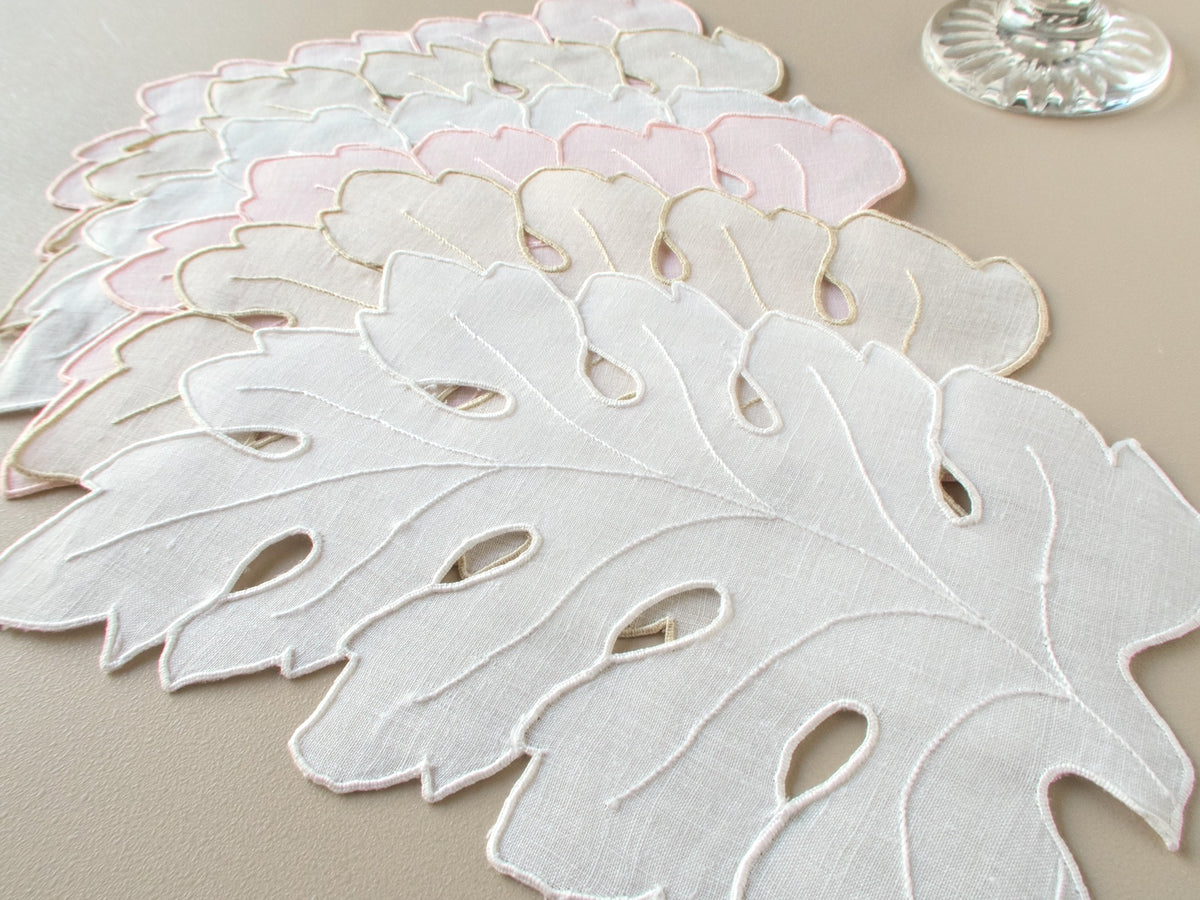 Vintage Madeira hand embroidered linen cocktail napkins in white, ecru and pale pink, fanned out to show full set of 6 leaf-shaped napkins
