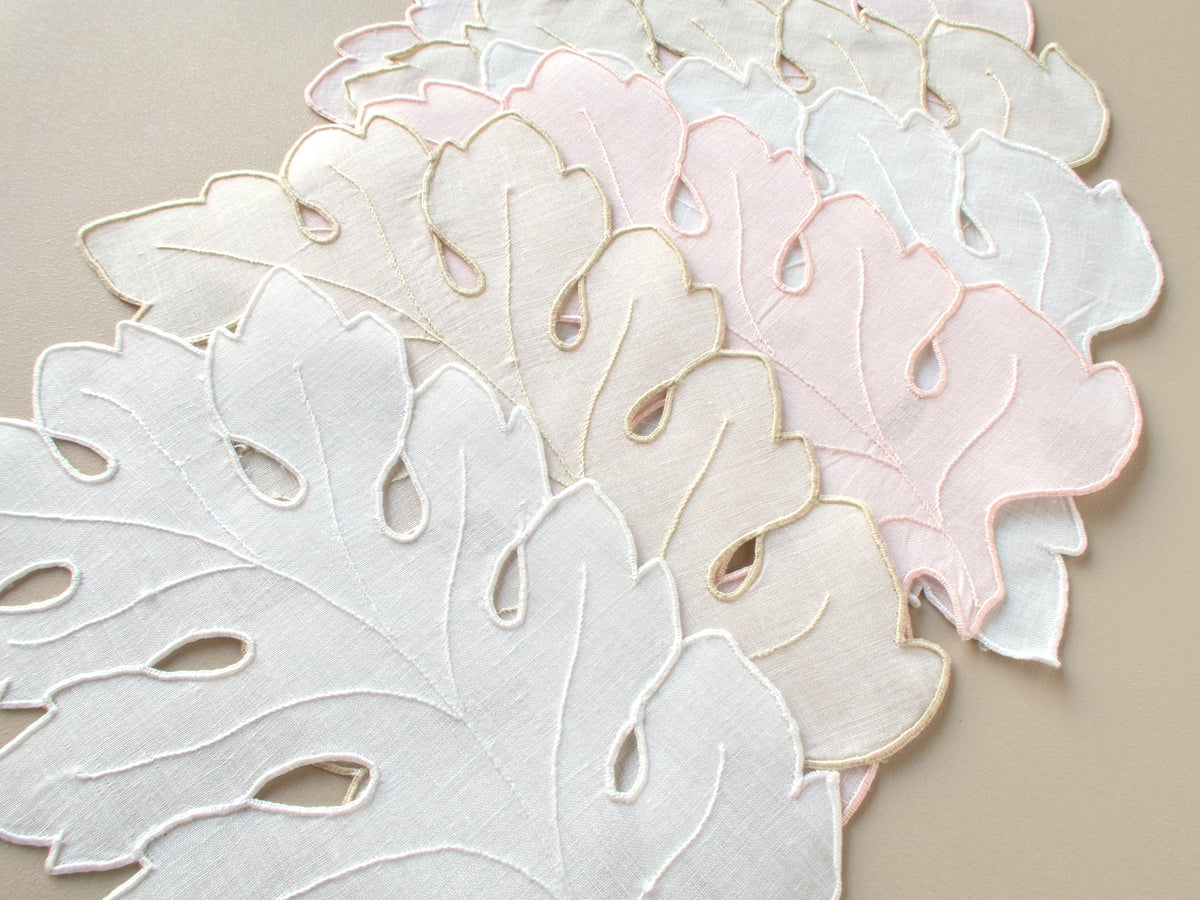 Close-up of vintage Madeira leaf-shaped cocktail napkins in white, ecru and pale pink, hand embroidered linen, set of 6​​​​​​​​​​​​​​​​