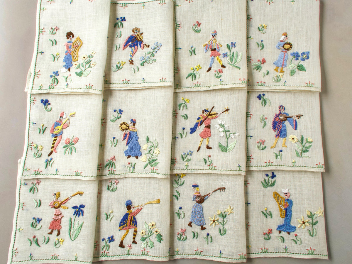 Full layout of all twelve Rapisardi medieval musician napkins arranged in a grid.