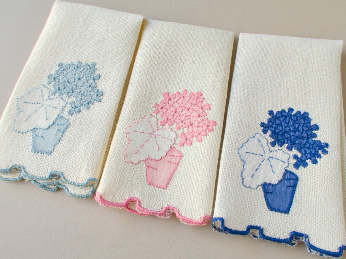 Three vintage Marghab marcasual linen “Geranium” fingertip towels in a wider view, showing all three colorways and stepped hems