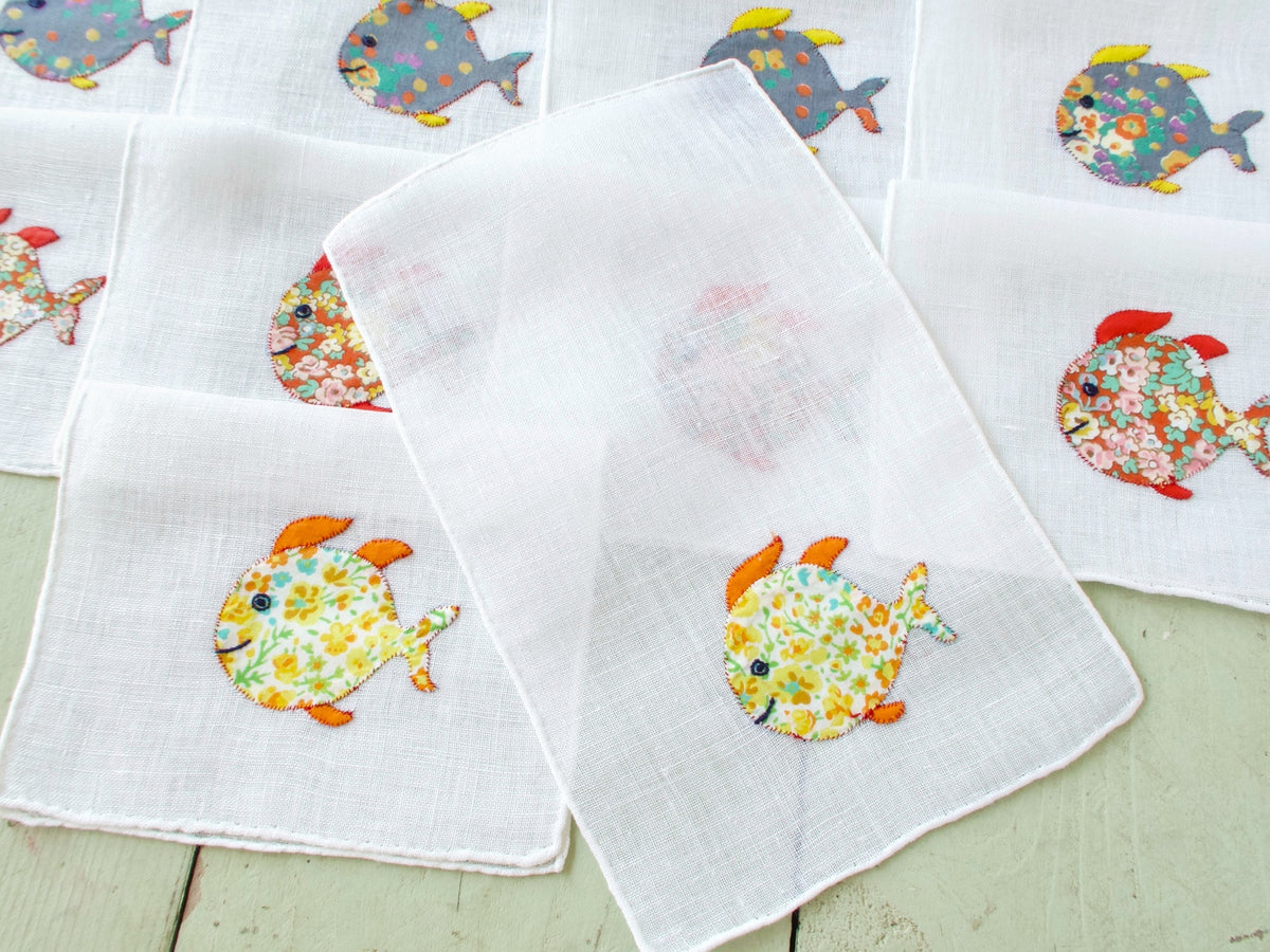 Single vintage Italian cocktail napkin, white semi-sheer linen with colorful floral appliqué fish​​​​​​​​​​​​​​​​
