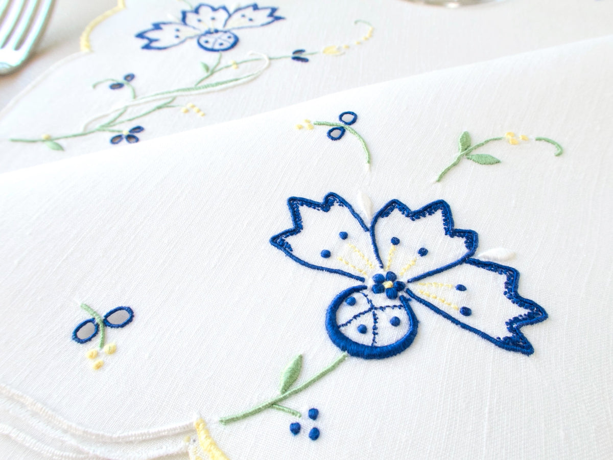 Close-up detail of vintage Madeira hand embroidery on white Irish linen​​​​​​​​​​​​​​​​