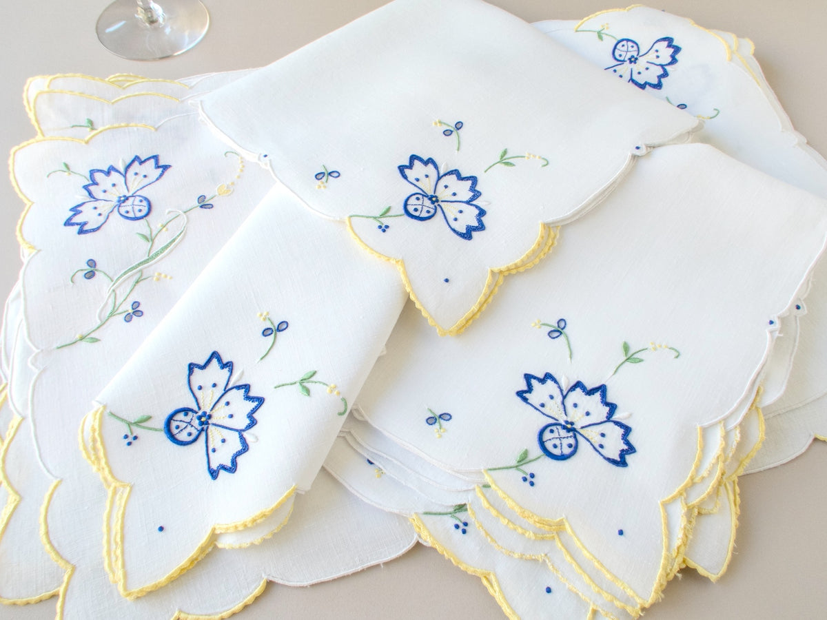 Multiple vintage Madeira placemats showing full blue cornflower design and scalloped border