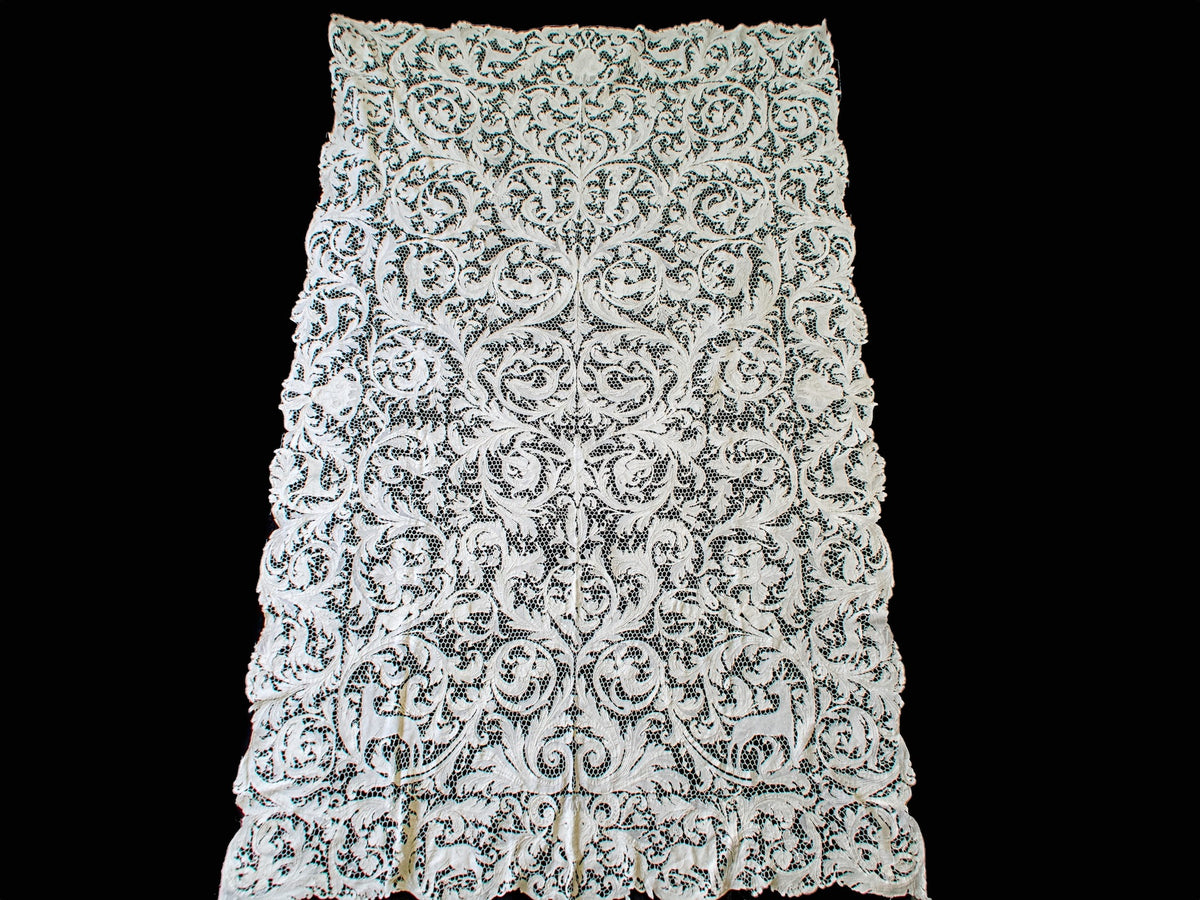 Full view of the rectangular lace tablecloth showing its repeating figural design.