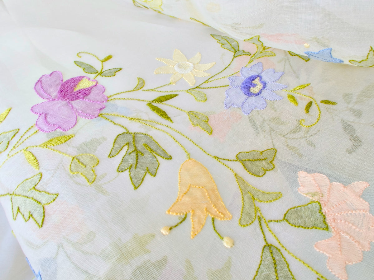 Detail of floral garland embroidery on vintage organdy tablecloth