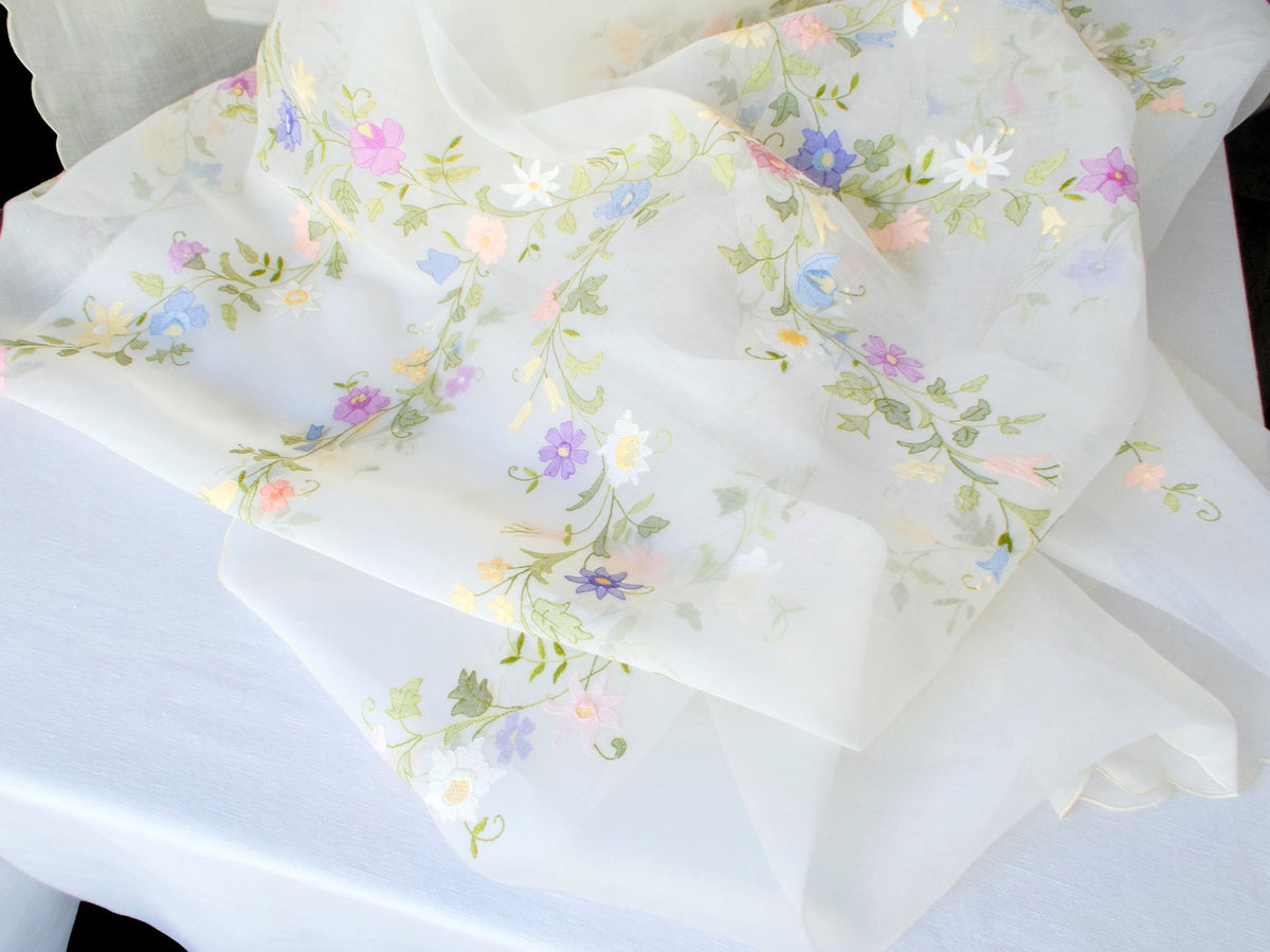 Detail of floral garland embroidery on vintage organdy tablecloth