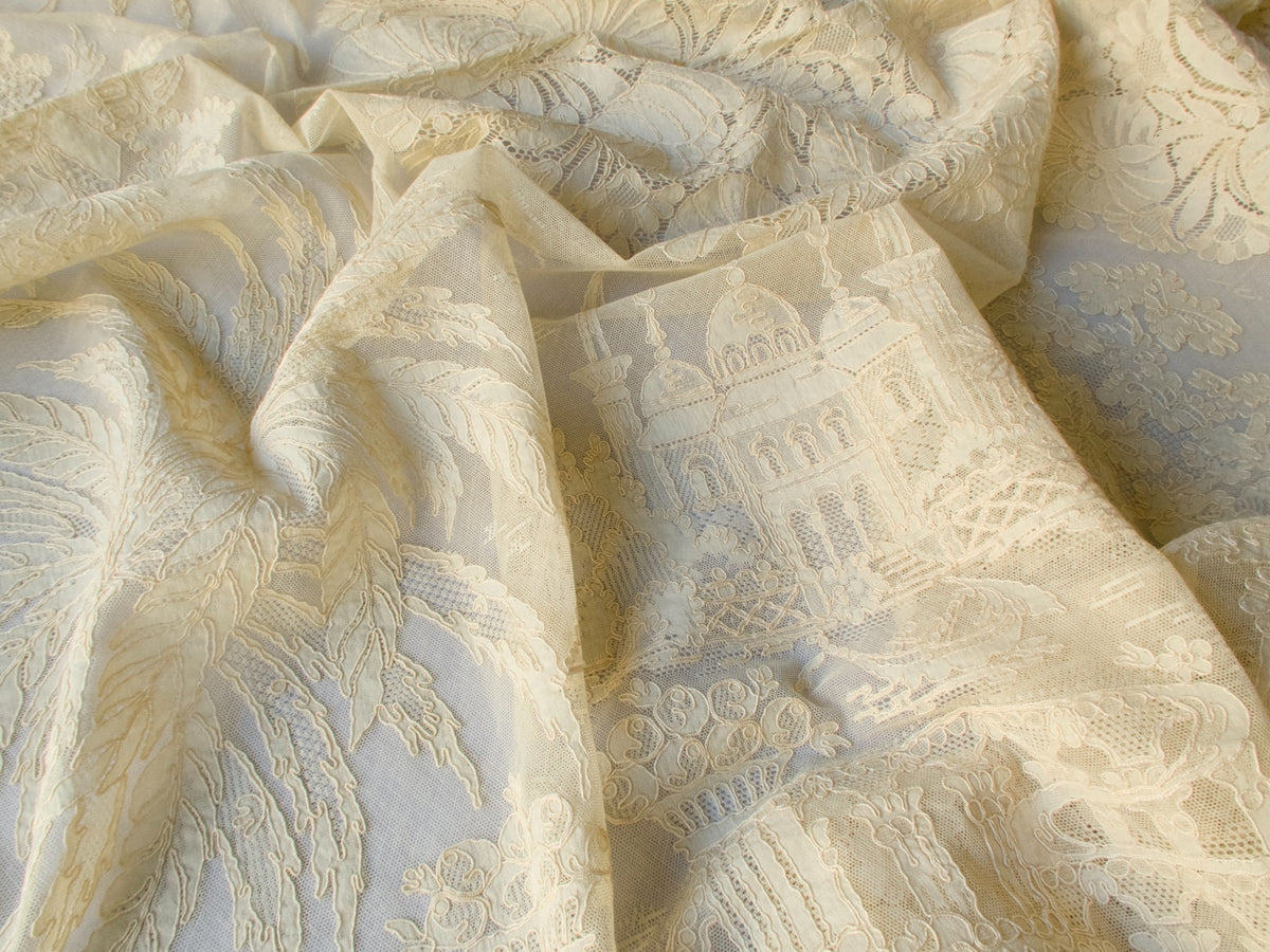 Close view of lace texture and patina on vintage French tablecloth