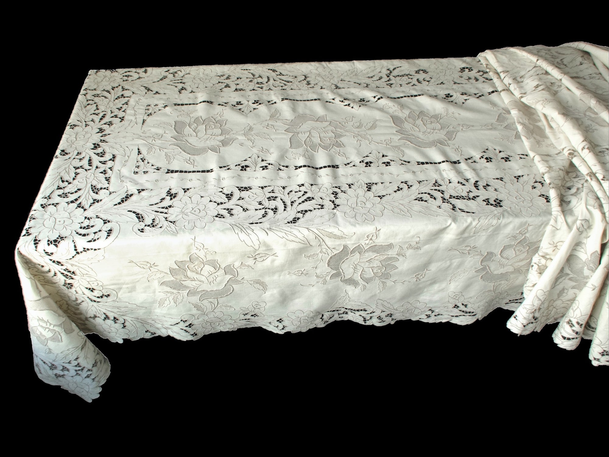 Corner of large Madeira tablecloth showing dense floral embroidery and intricate connecting bars.