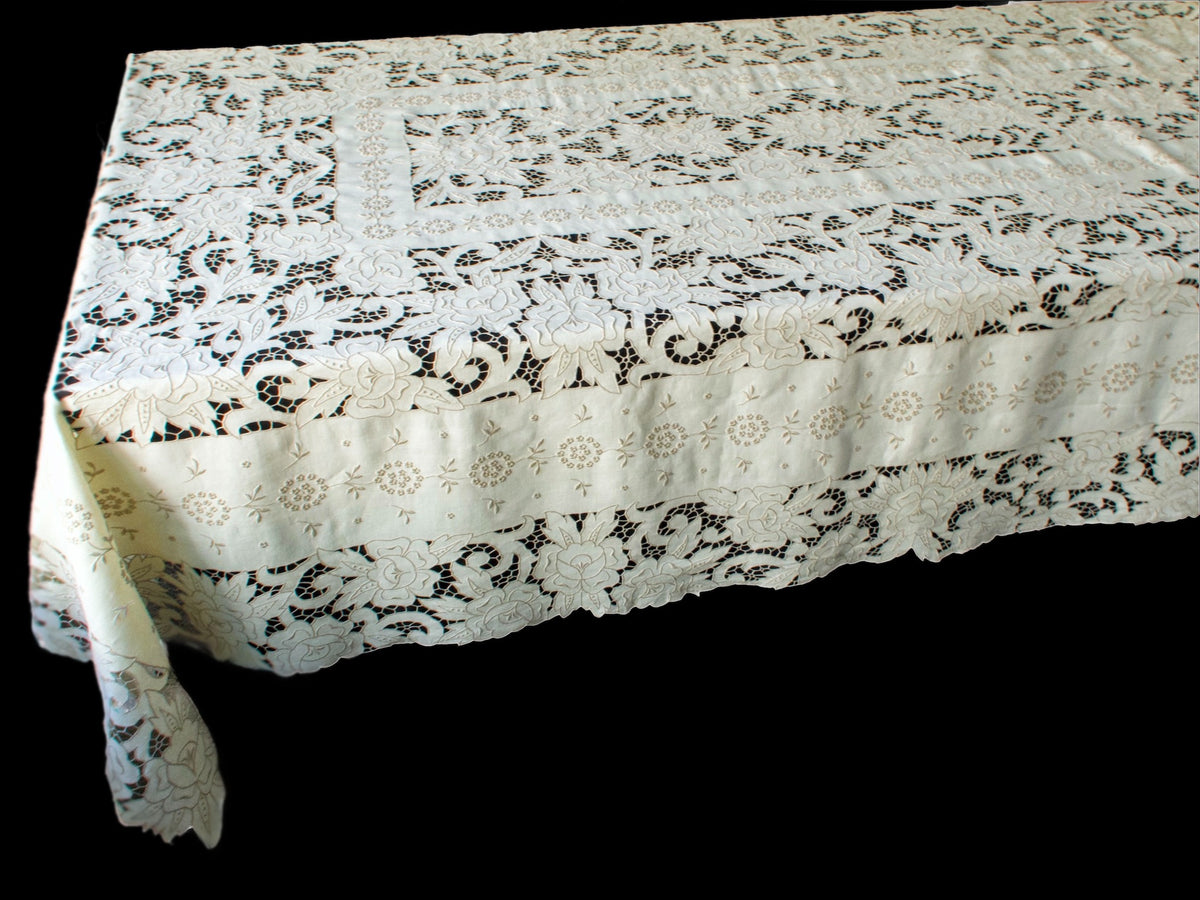 Hand-embroidered corner detail of Madeira Richelieu tablecloth, with openwork bridges and fine satin stitching.