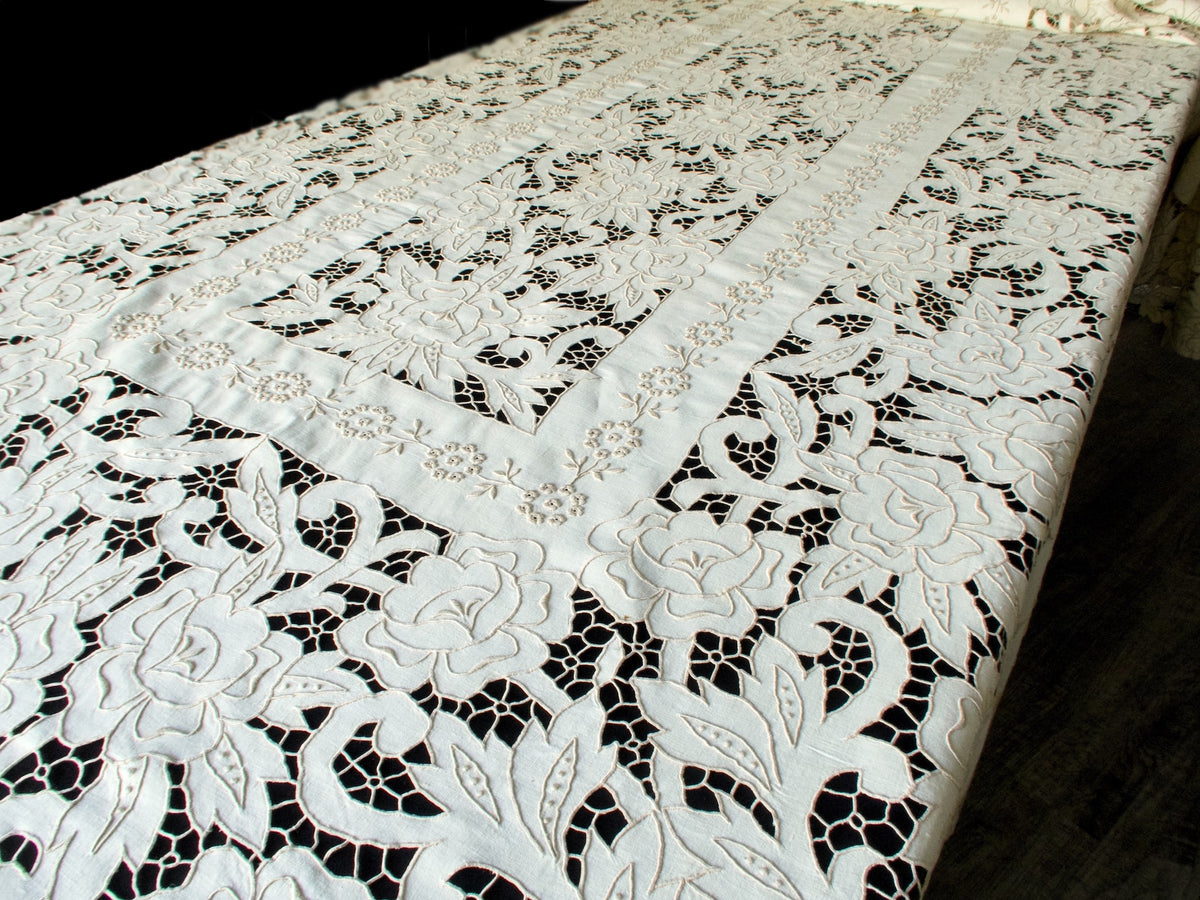Full view of The Grand Madeira, 22-foot hand-embroidered linen tablecloth with intricate cutwork and raised floral embroidery.