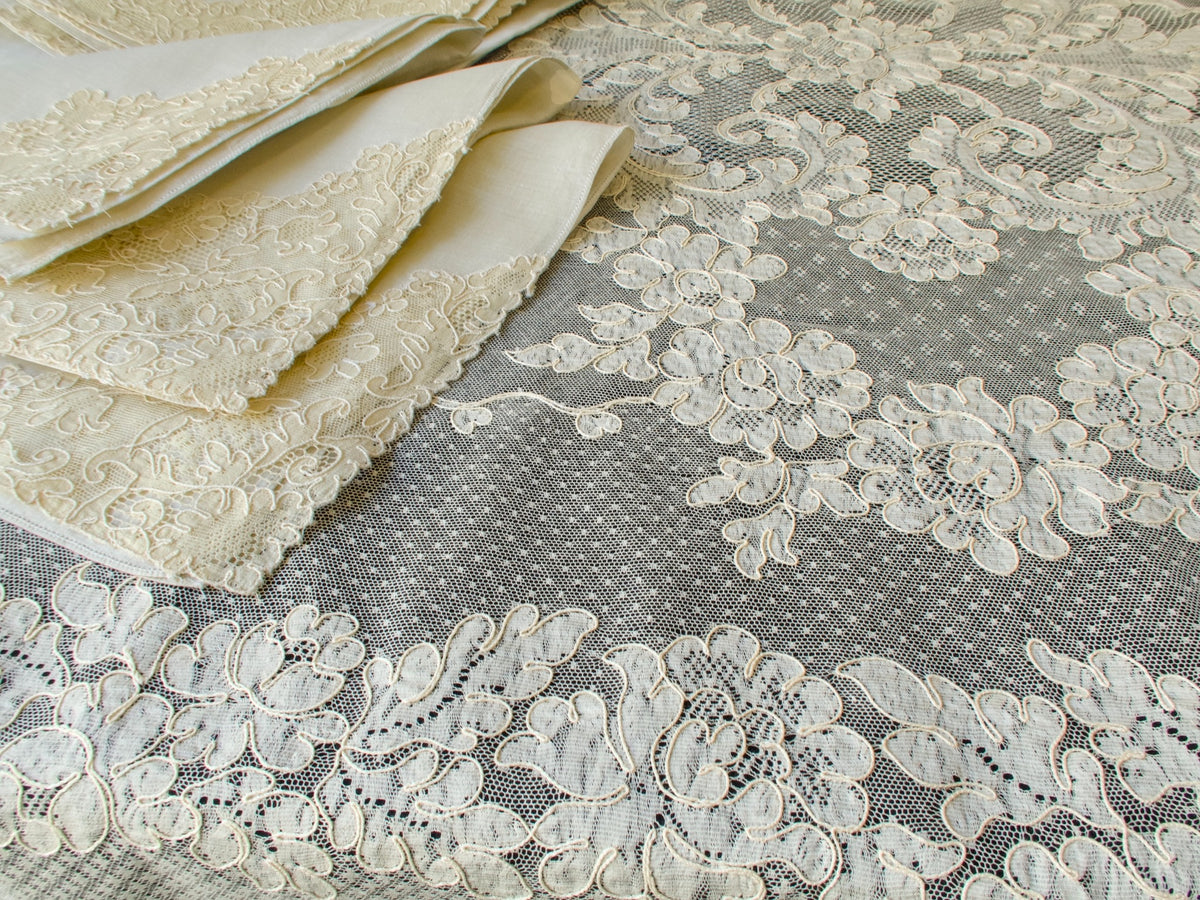 Close view of floral Alençon lace pattern with raised embroidery and mesh ground